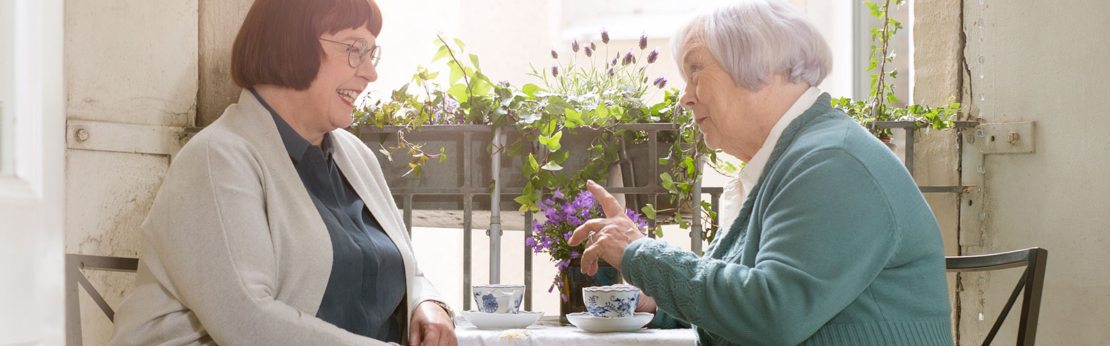 Two women having coffee on the balcony Two women having coffee on the balcony